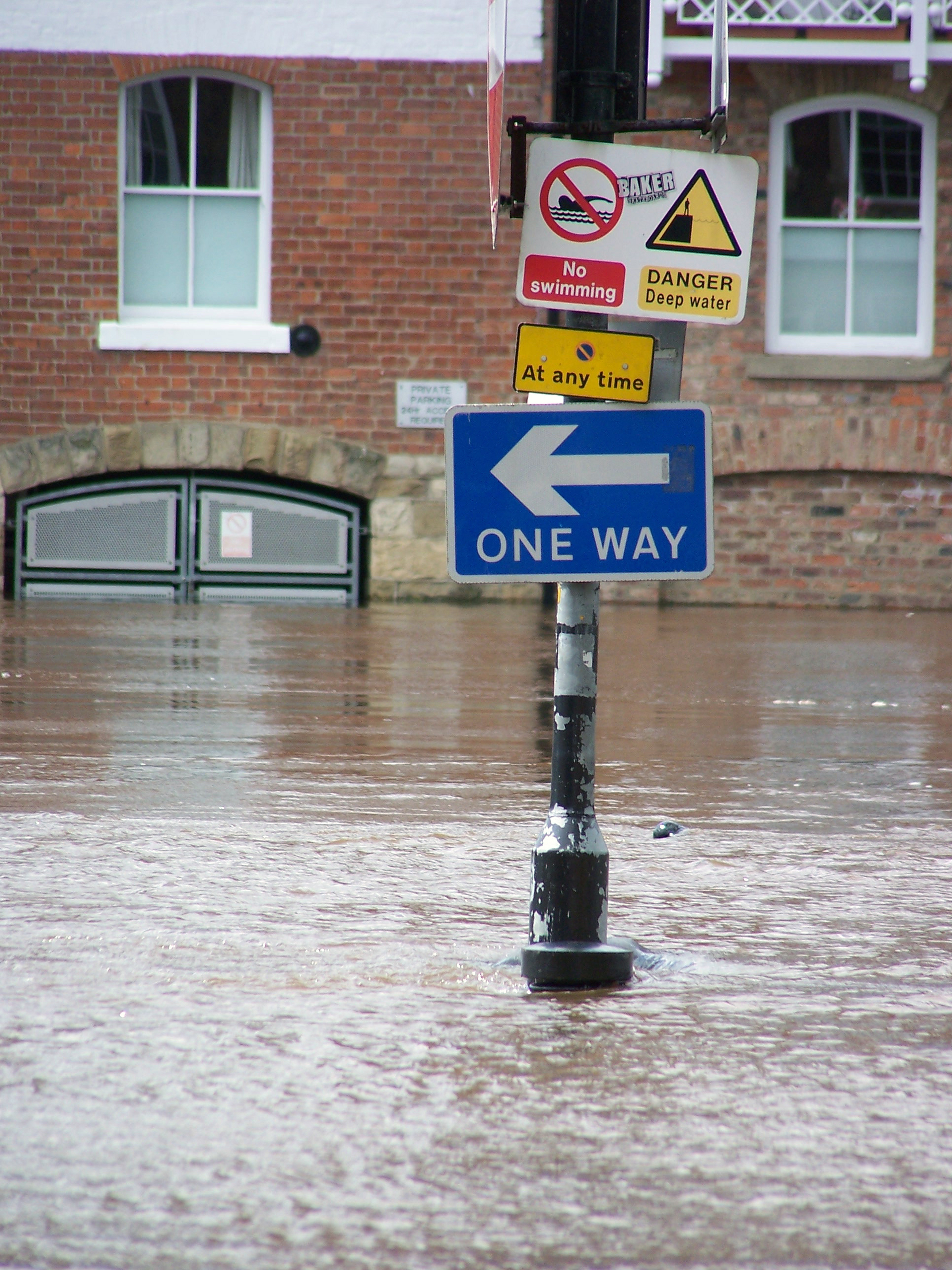 Flooded road with signs sticking out of the water