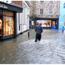 Example of property flood barriers protecting businesses in a flooded town centre 