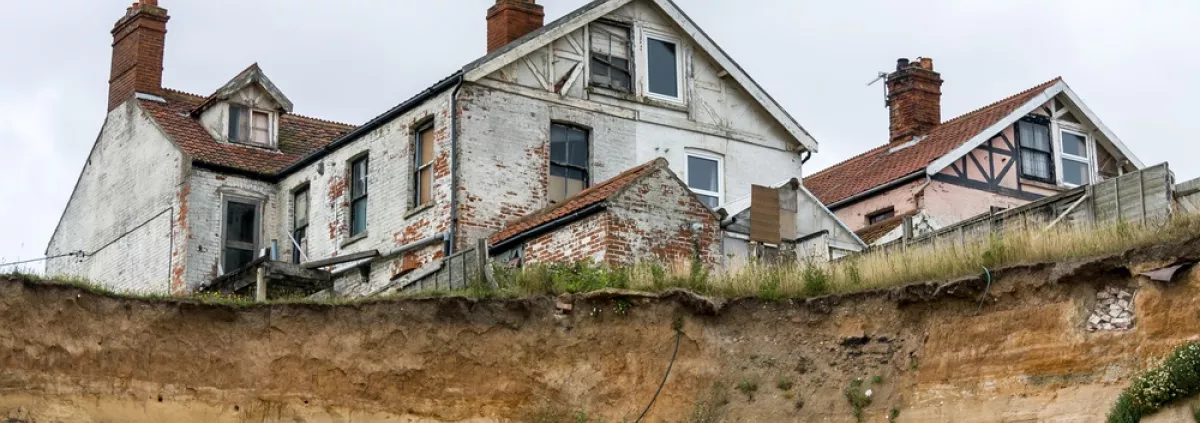 A house near a cliff edge in Hapisburgh, Norfolk, UK